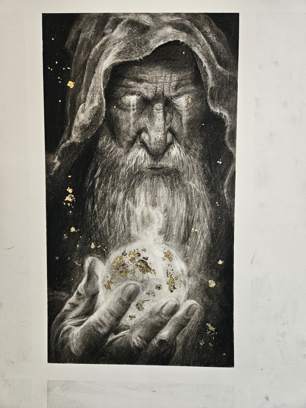 Hooded figure holding a glowing orb