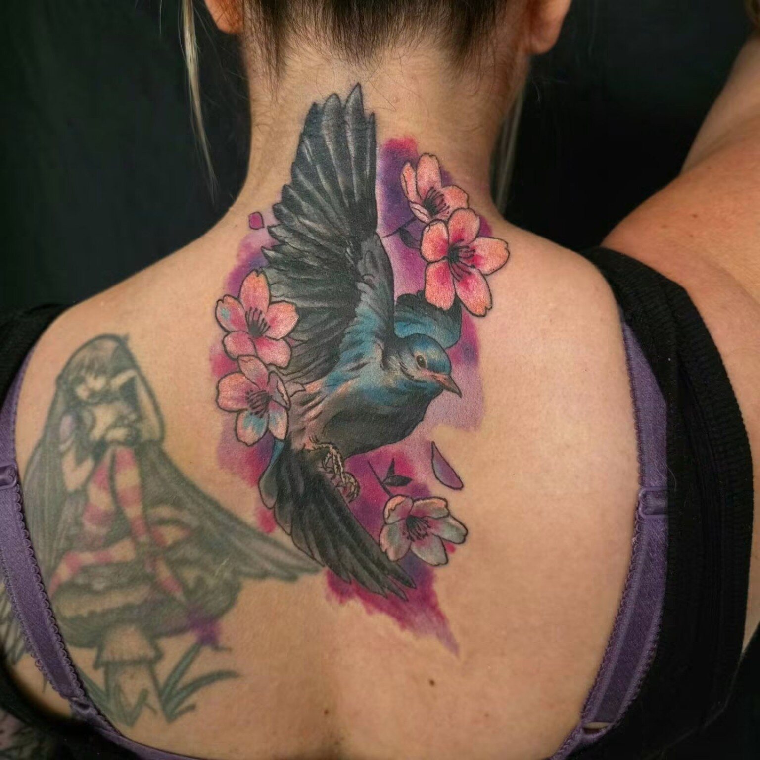 Blue bird and flowers tattoo after rework