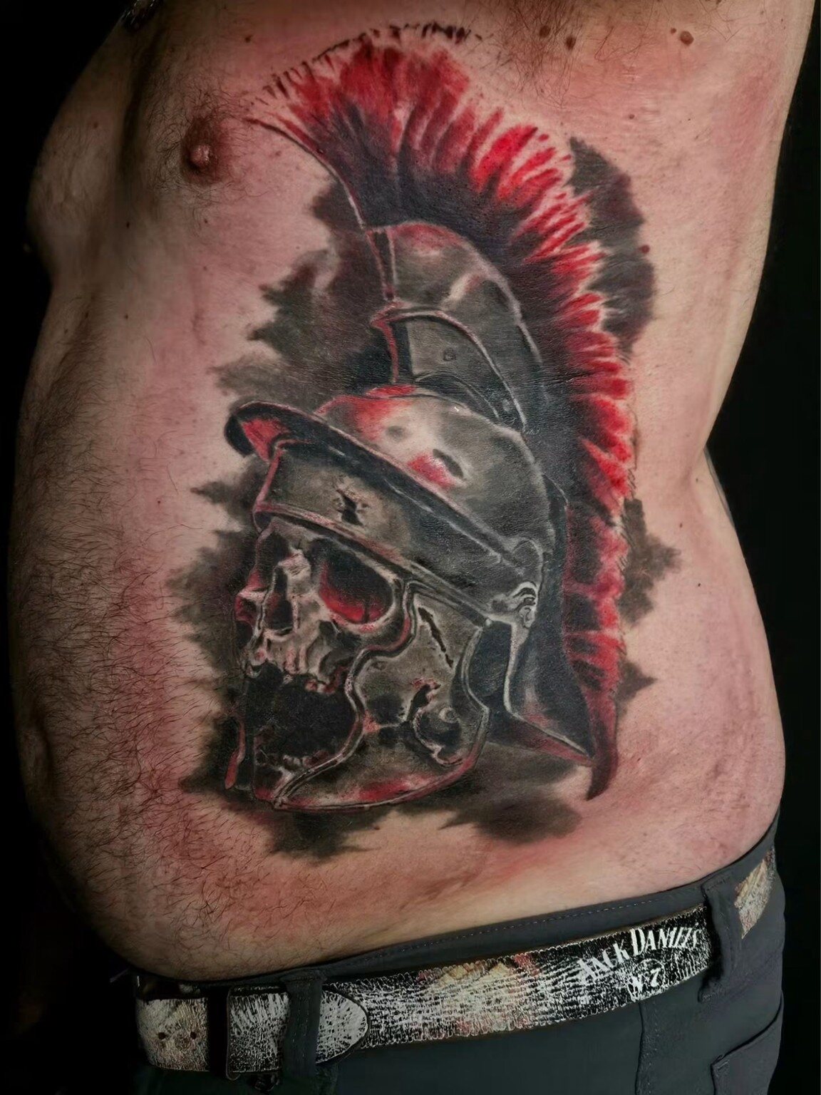 Roman helmet and skull tattoo after cover-up